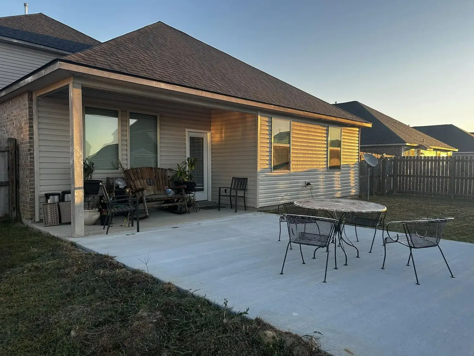 Custom patio cover over a backyard patio at golden hour in the Baton Rouge area