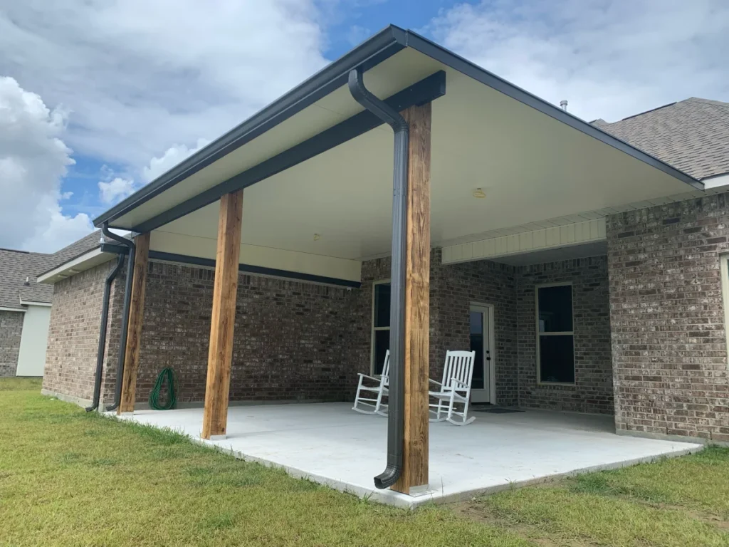 tiger town construction insulated patio cover cedar columns rocking chairs brick home
