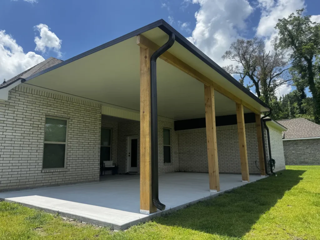 tiger town construction insulated patio cover cedar columns white brick home blue sky