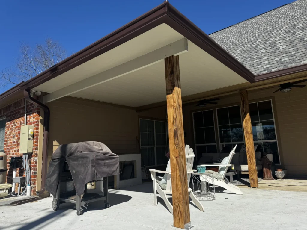 tiger town construction insulated patio cover rustic cedar columns brick home adirondack chairs