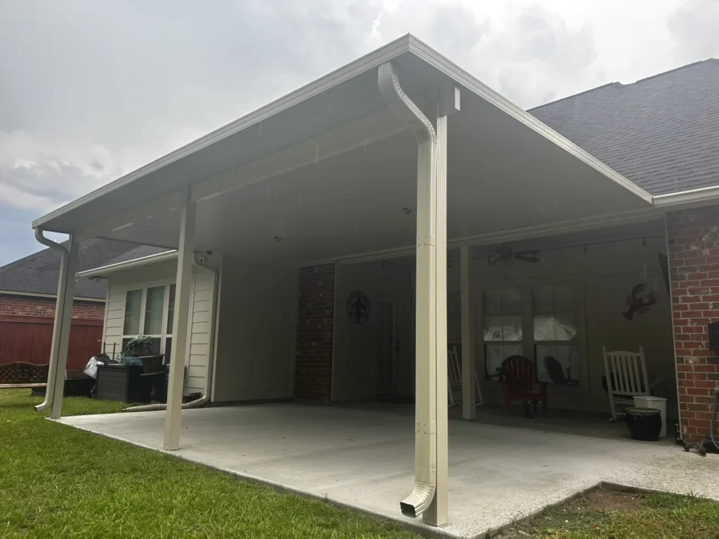 tiger town construction insulated patio cover tan frame rocking chairs brick home cloudy