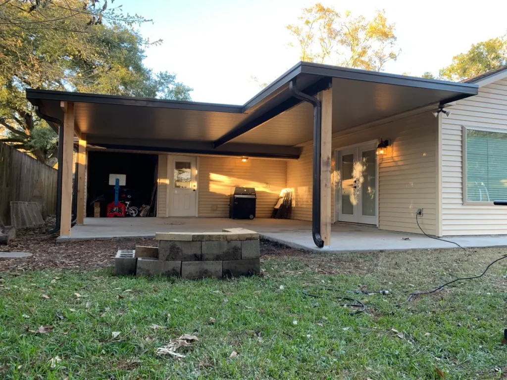 tiger town construction non insulated patio cover cedar columns tan home firepit evening
